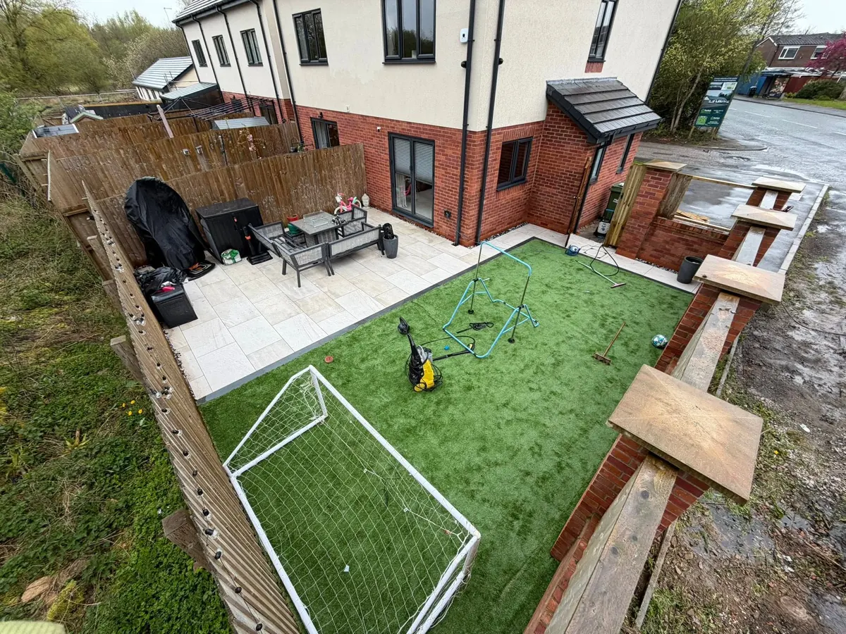 Aerial view of a landscaped rear garden with new fencing, porcelain patio and artificial lawn